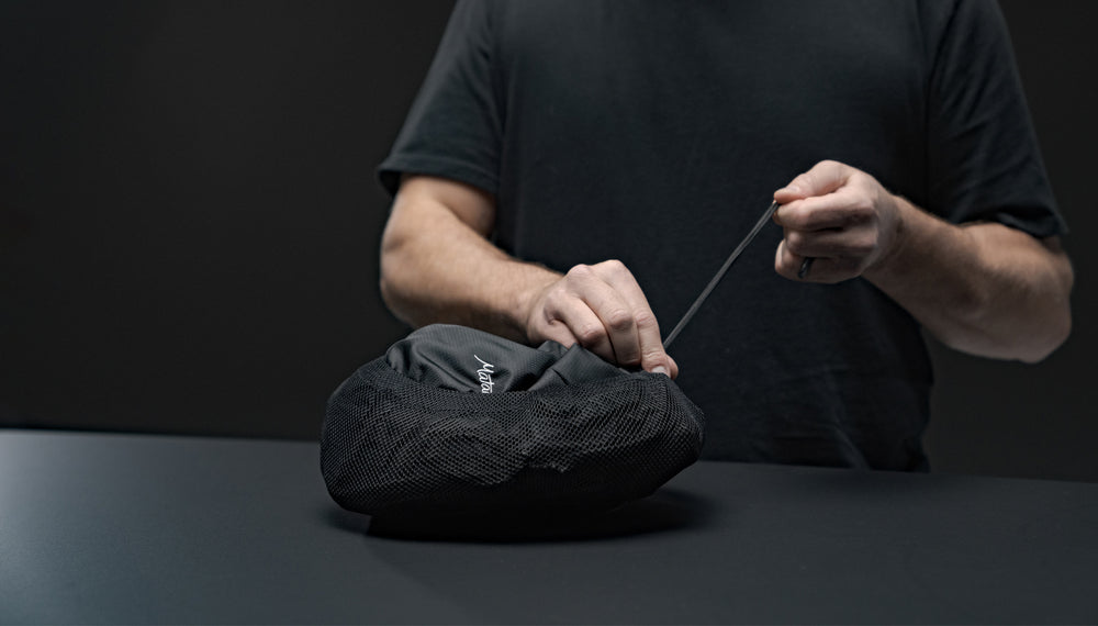 Hands cinching Beast18 into compression sack