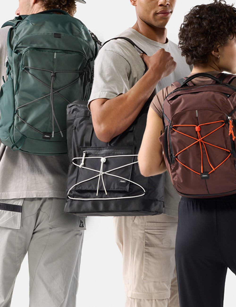 three people with juniper, black, and garnet pack with different colored cord and zippers