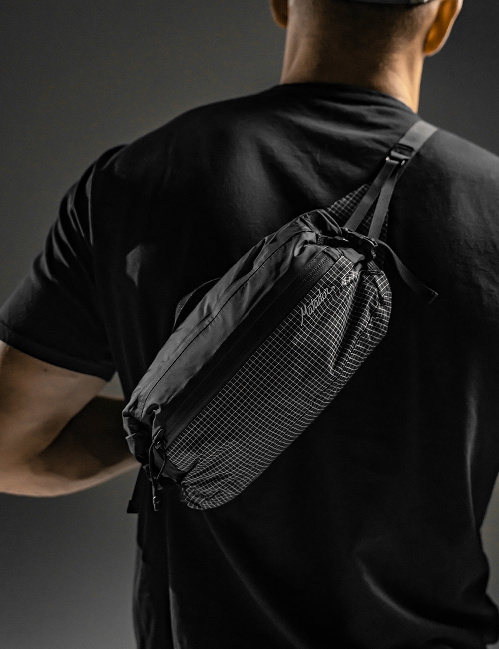 man wearing sling across his back