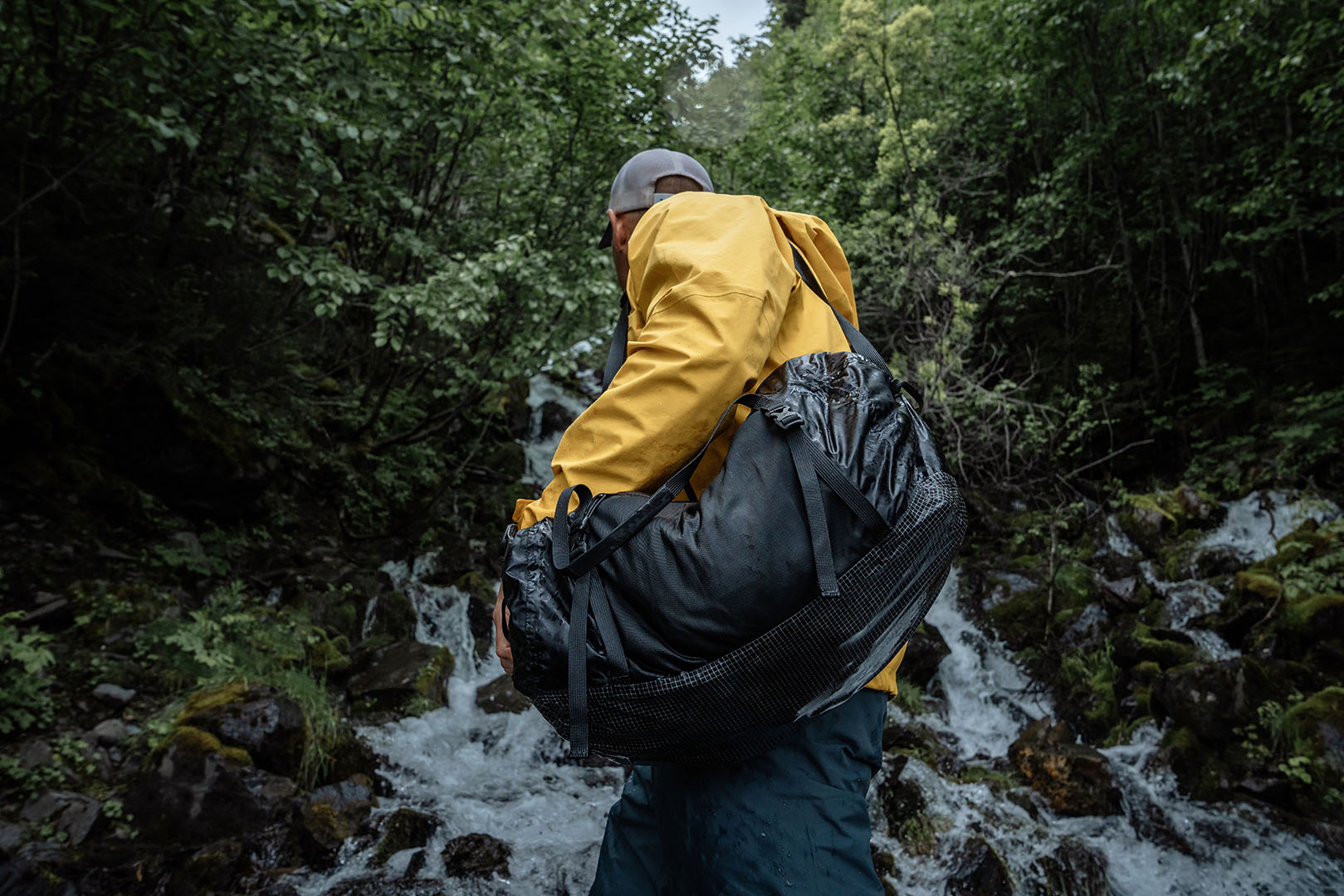 a person exploring a waterfall with a waterproof bag