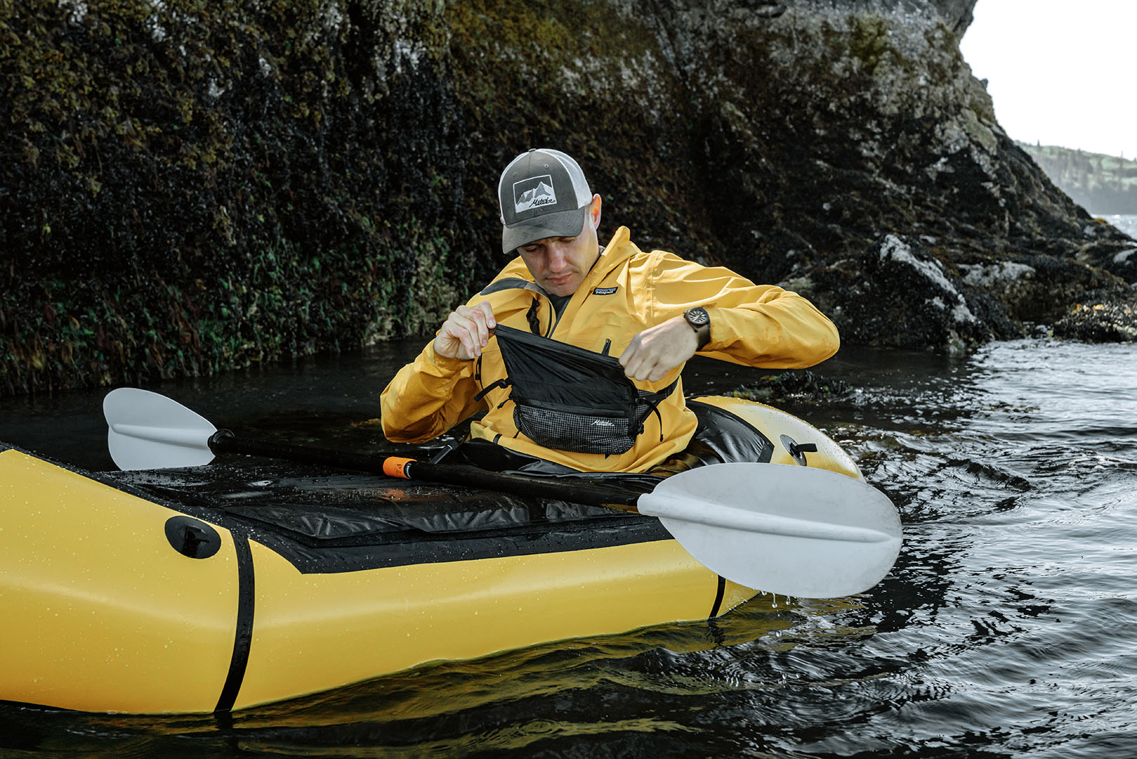 man kayaking and using his waterproof sling bag for water activities