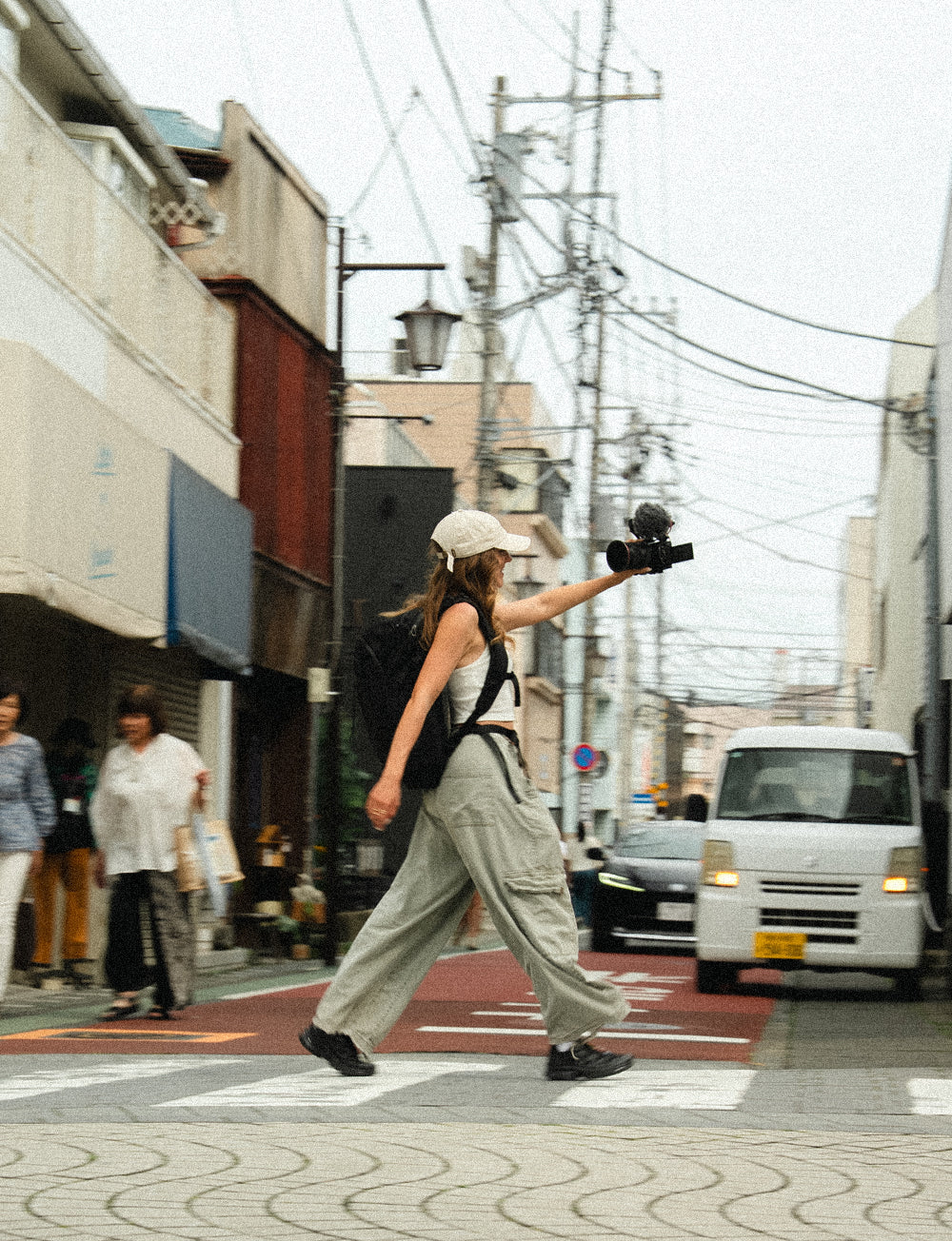 Person at Japanese crosswalk filming self