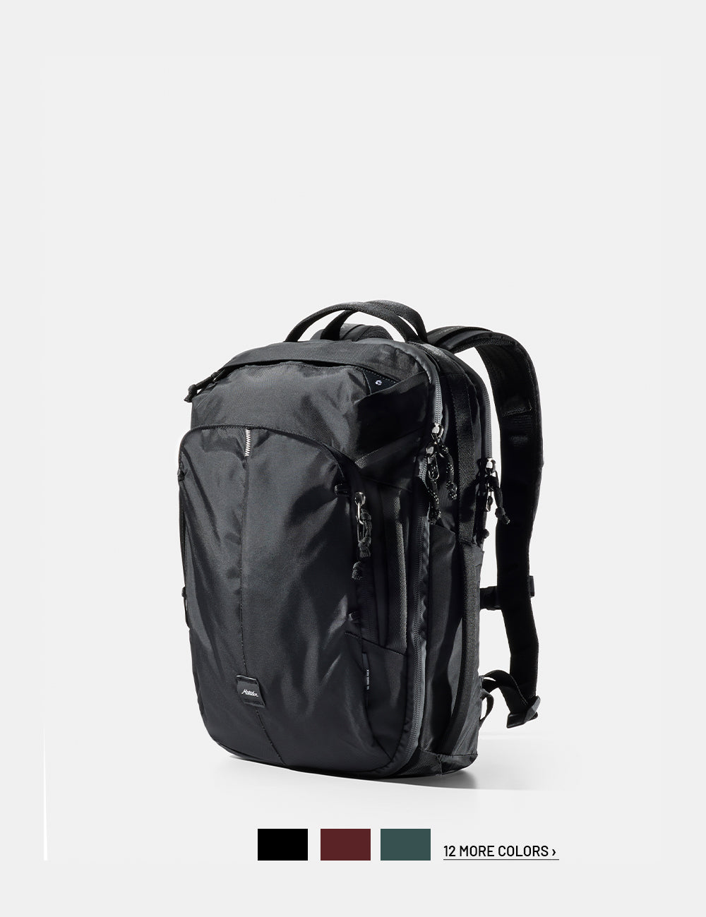 Black backpack on a white background with 3 color swatches and text that reads "12 more colors"