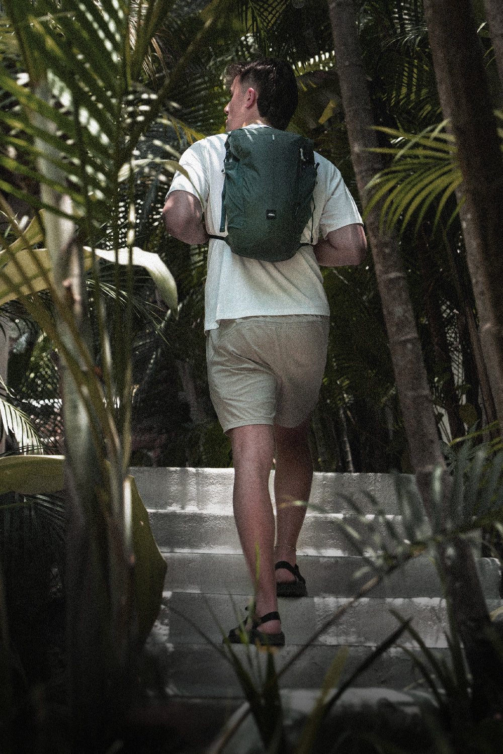 person on jungle path wearing juniper backpack