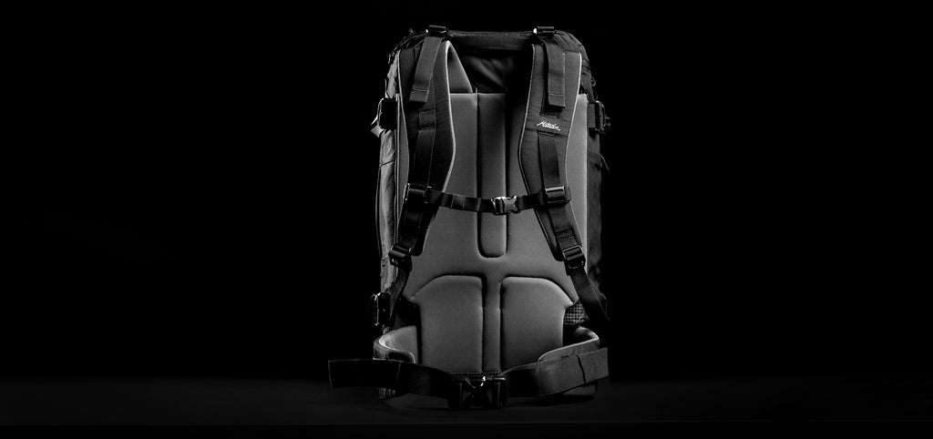 back view of GlobeRider45 backpack straps on black background