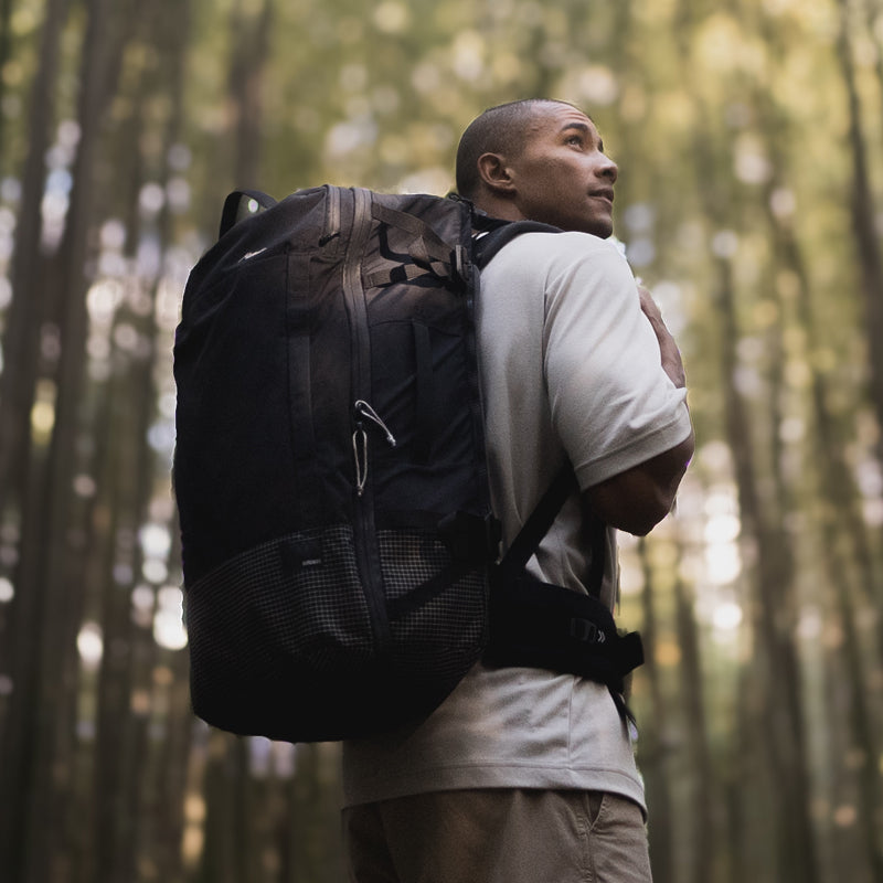 man in bamboo forest wearing GlobeRider45 travel pack on his back