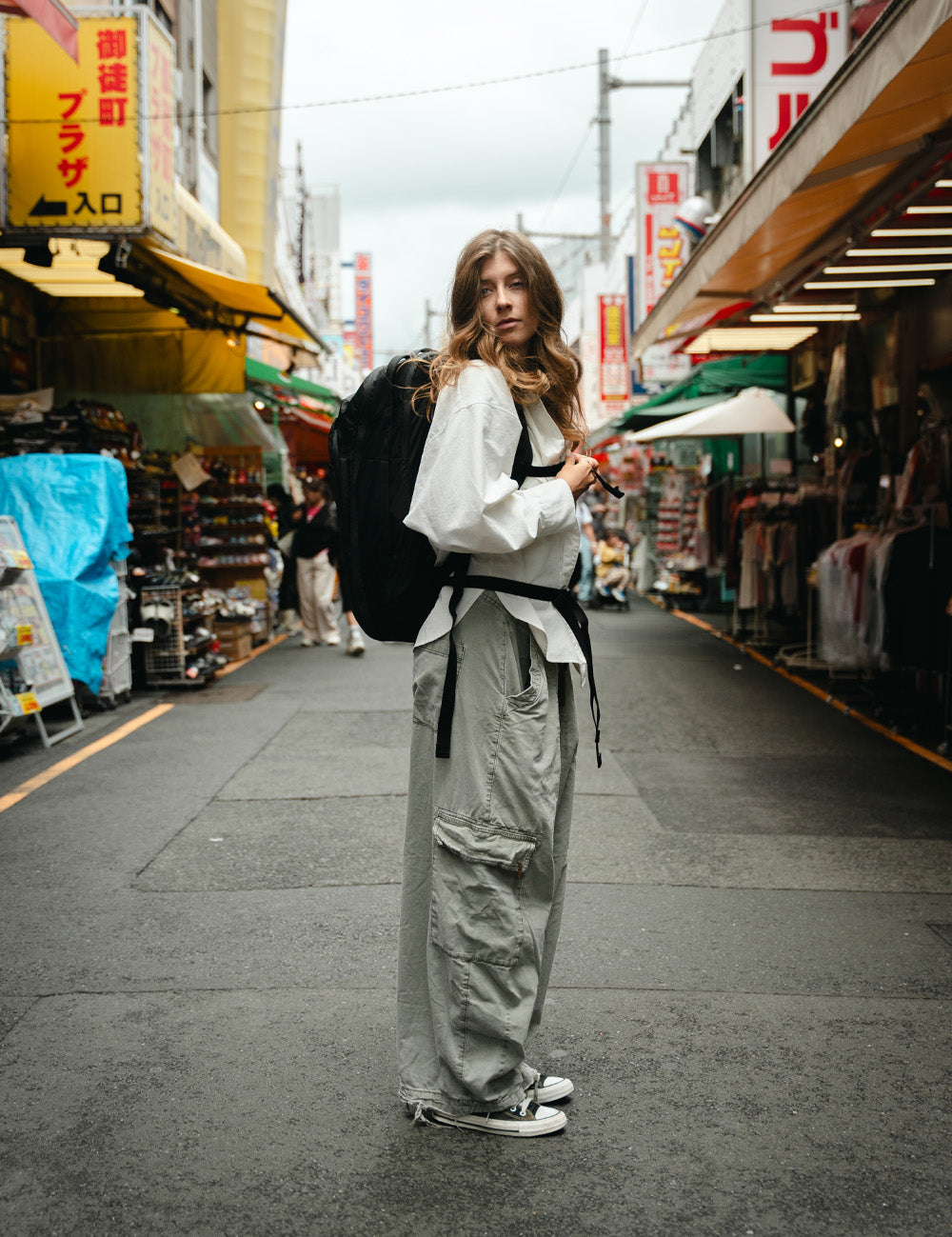 Person standing in the middle of a Japanese market