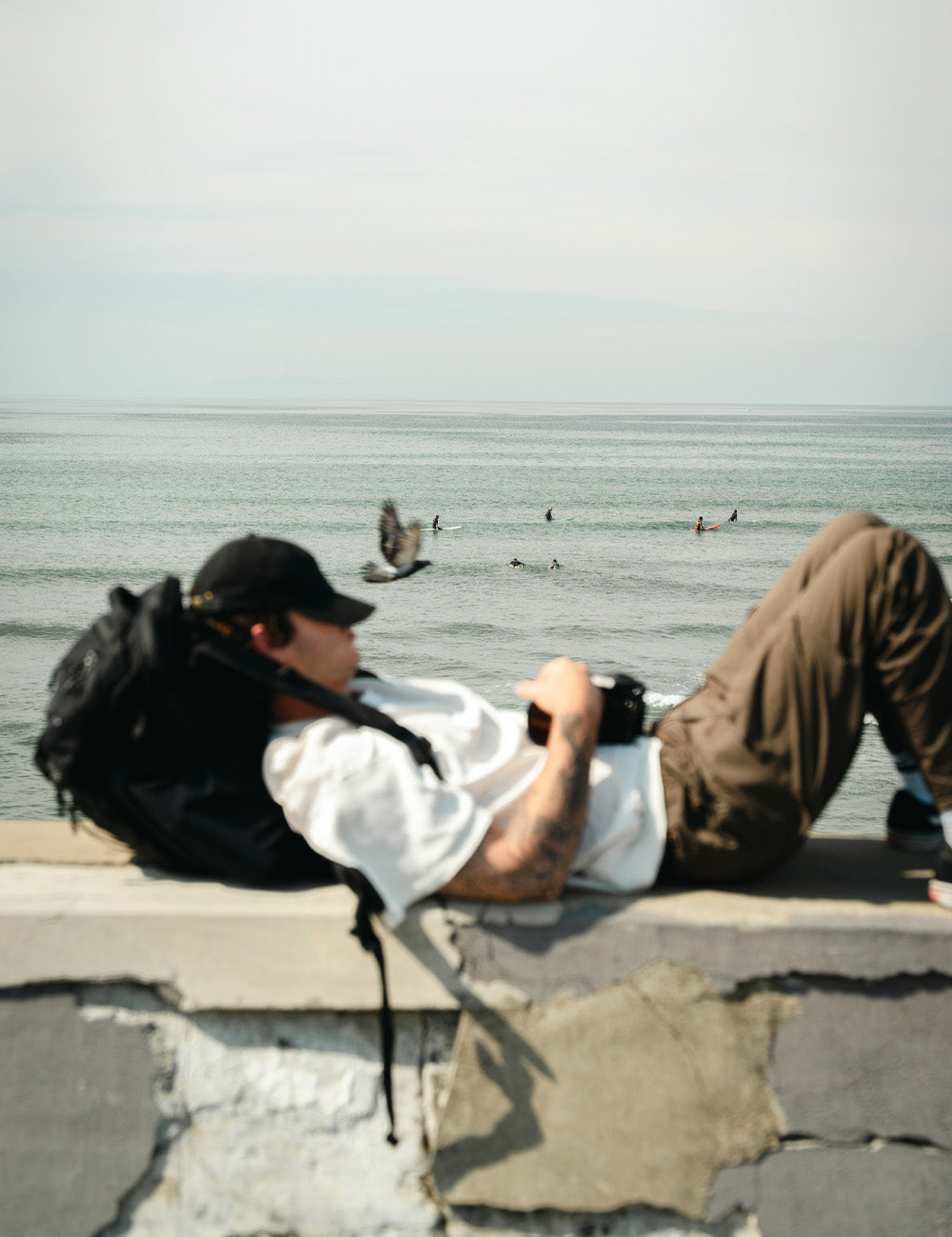 person napping on the edge of the ocean