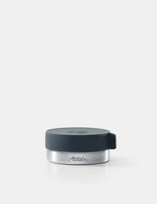 Silver container with a black lid on a white background
