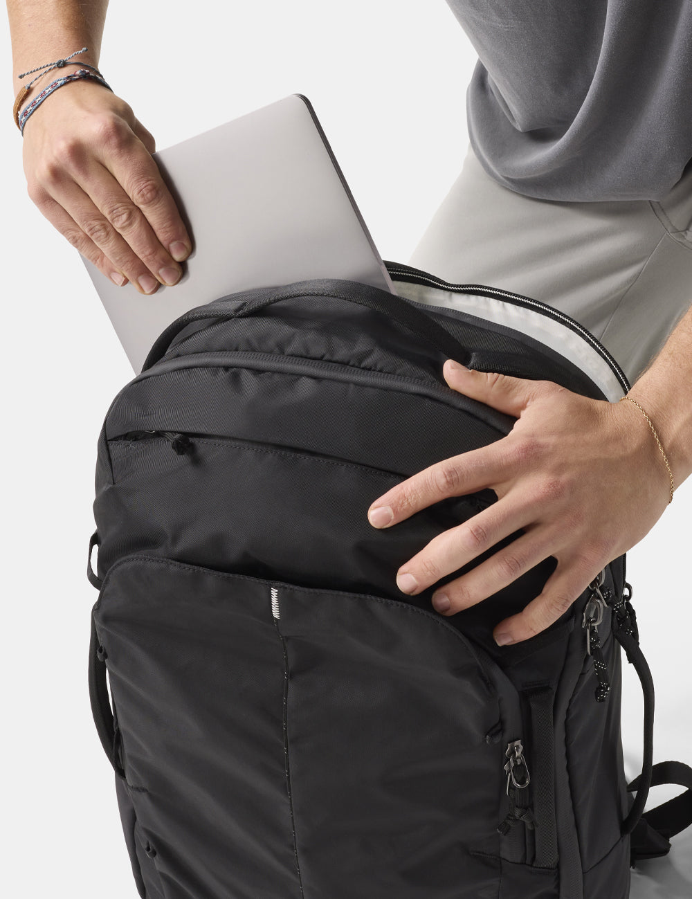 laptop going into black backpack