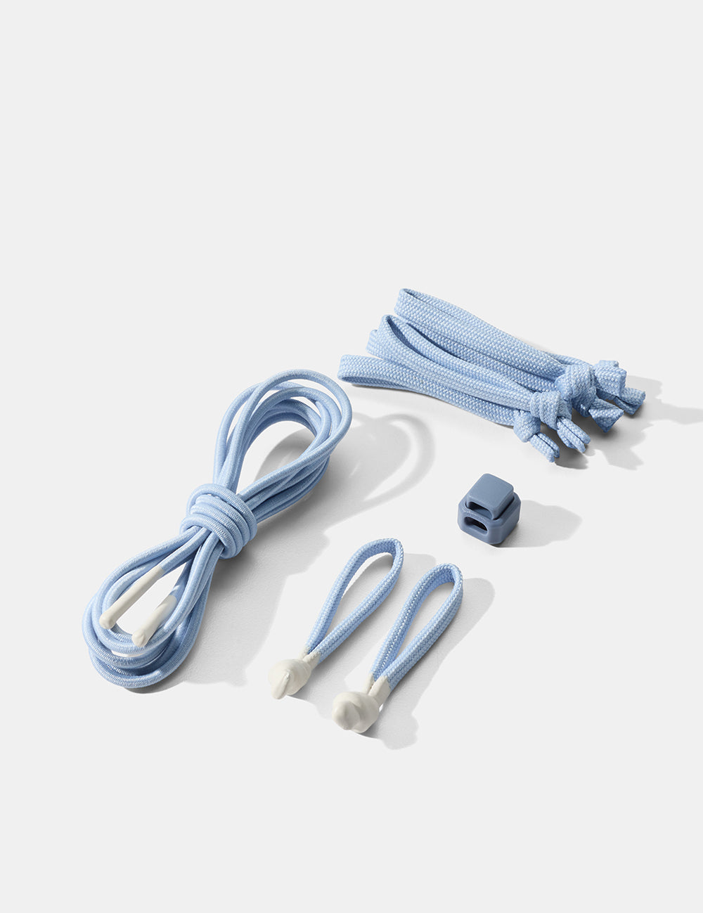 Set of light blue cord and zipper pullers on a white background