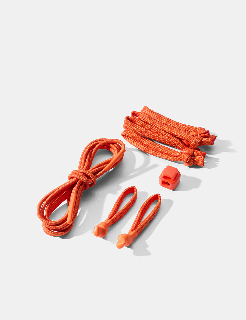 Set of orange cord and zipper pulls on a white background