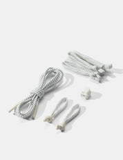 Set of white zipper pullers and tabs on a light gray background