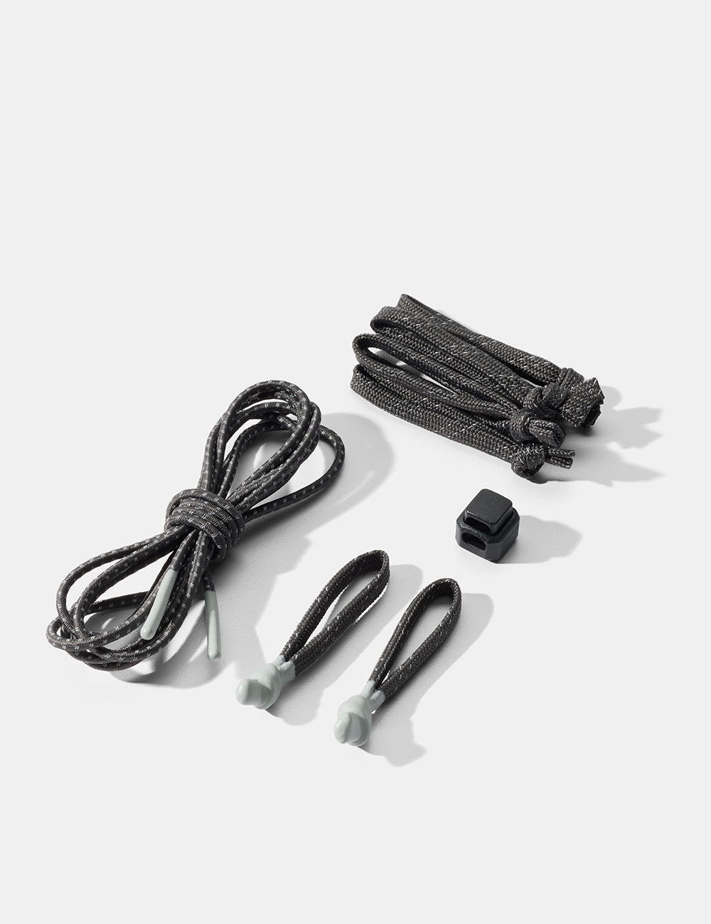 Set of black cord and zipper pullers on a white background
