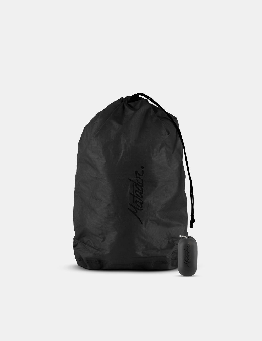 Black drawstring bag with a small black container on a light gray background