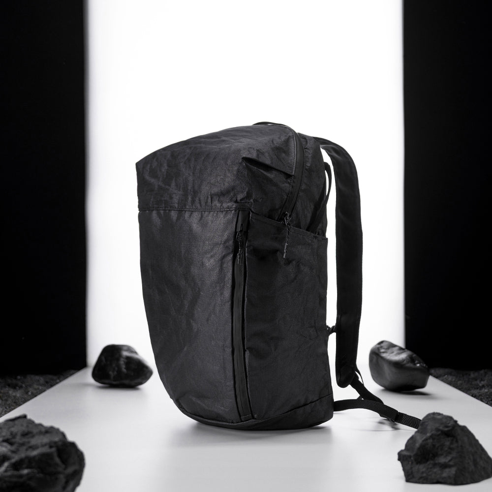 black backpack on light up white studio background