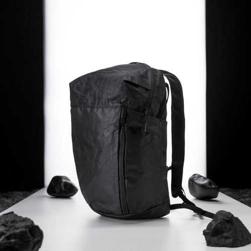 black backpack on light up white studio background