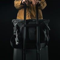 messenger bag luggage pass-through slid onto rolling luggage