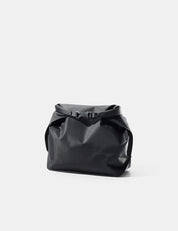 Black toiletry case on a light gray background