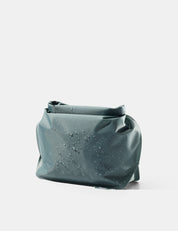 Blue-green toiletry bag on a white background