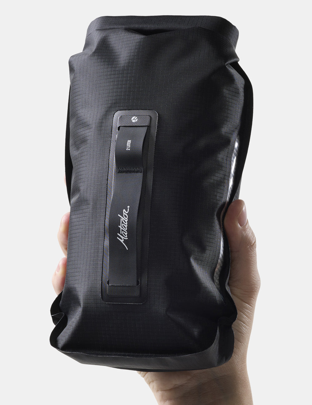 hand holding black dry bag on white background