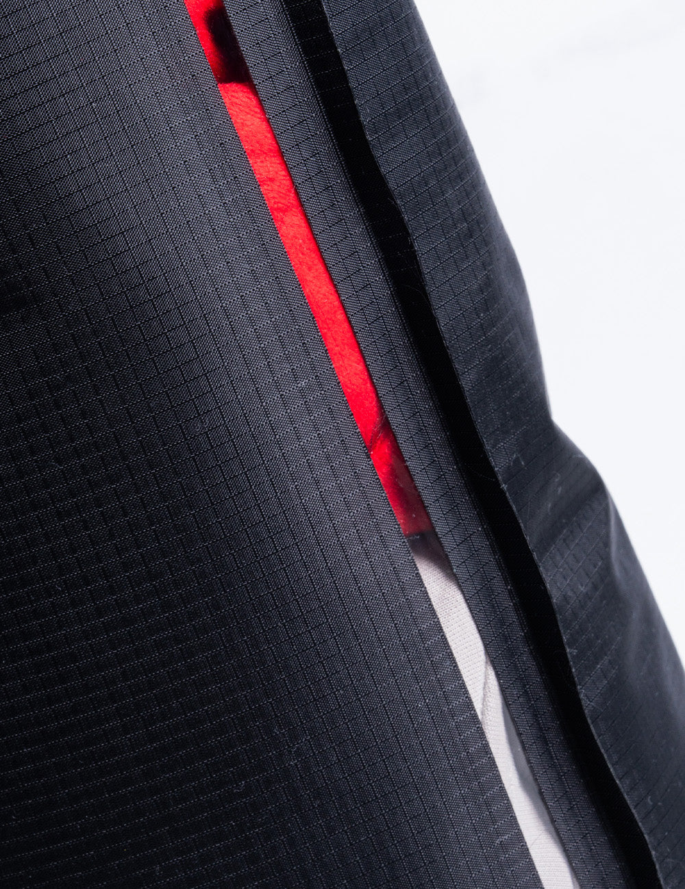 red and white material showing through viewing window of dry bag