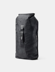 Black waterproof roll-top bag with water droplets on a white background