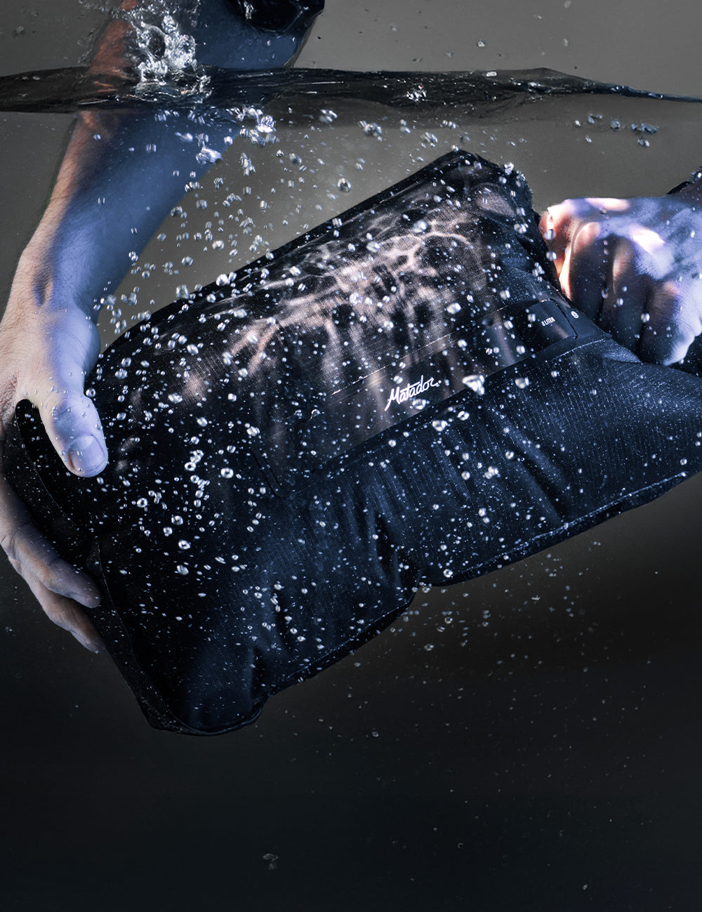 black dry bag fully submersed in water