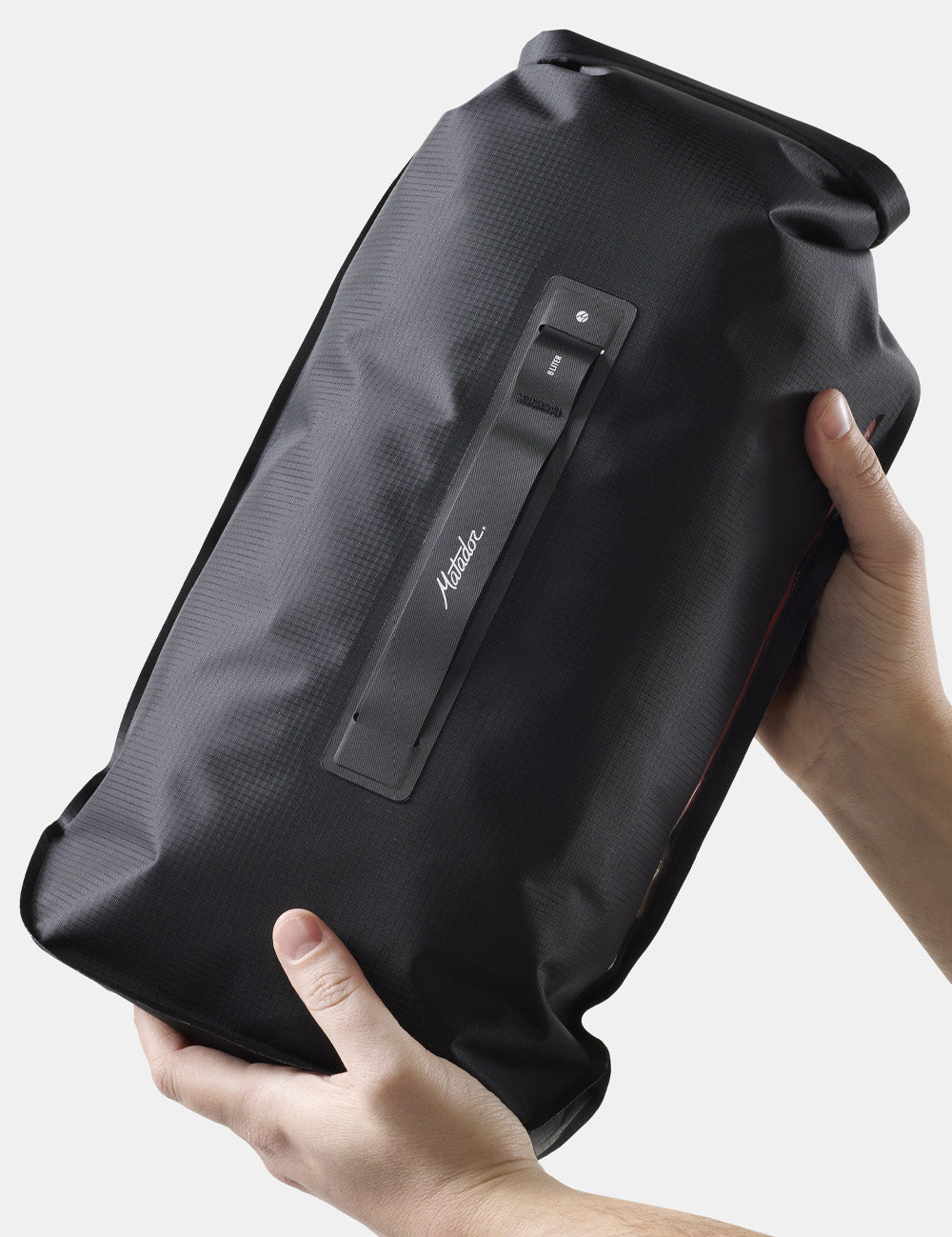 hands holding black dry bag on white background 