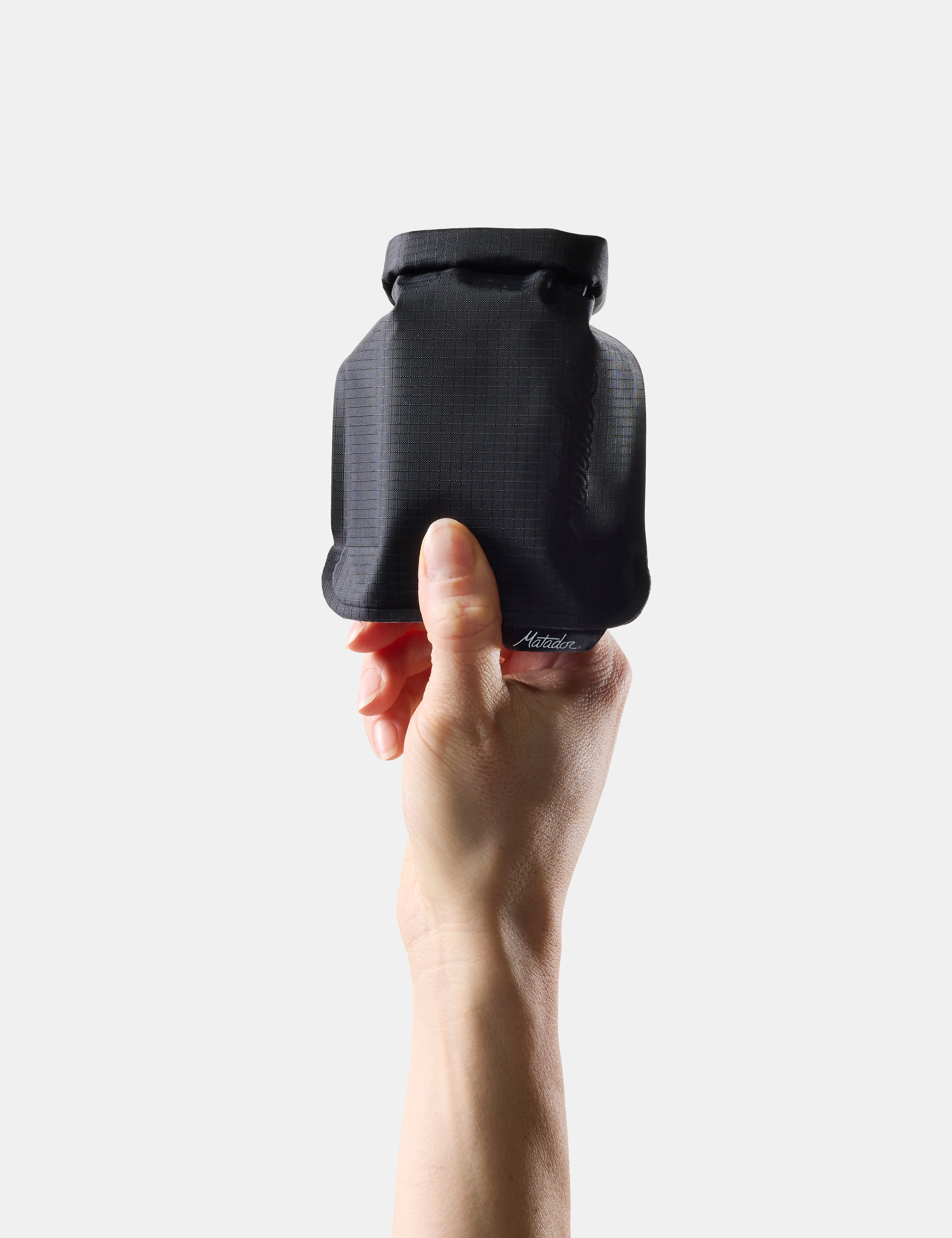 Hand holding Black soap bar case against a white background