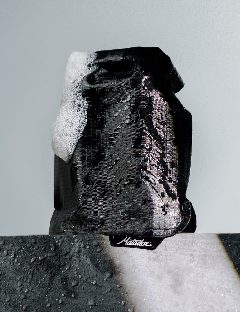 black soap bar case covered in suds