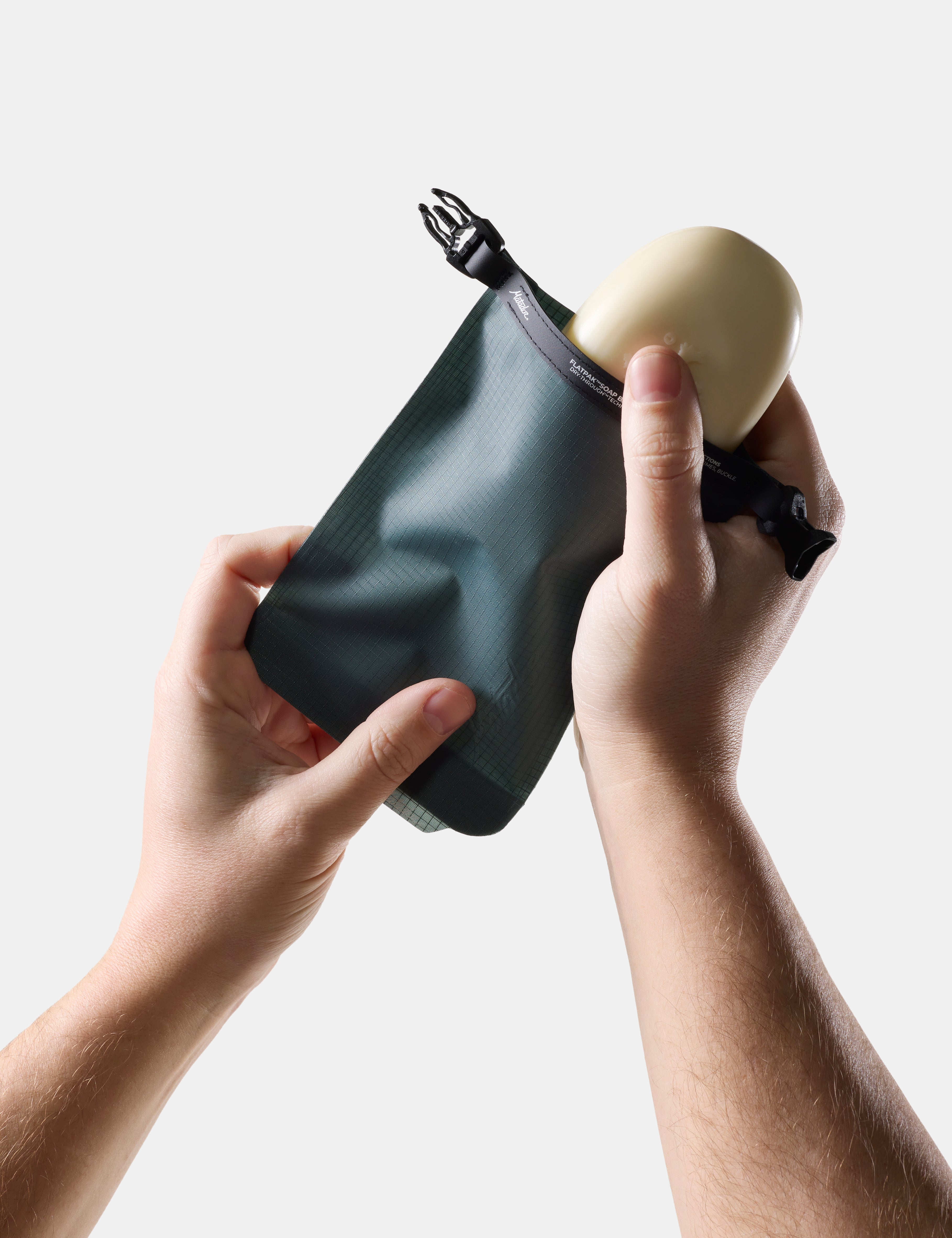 Person holding Blue-green soap bar case  and soap on a light background