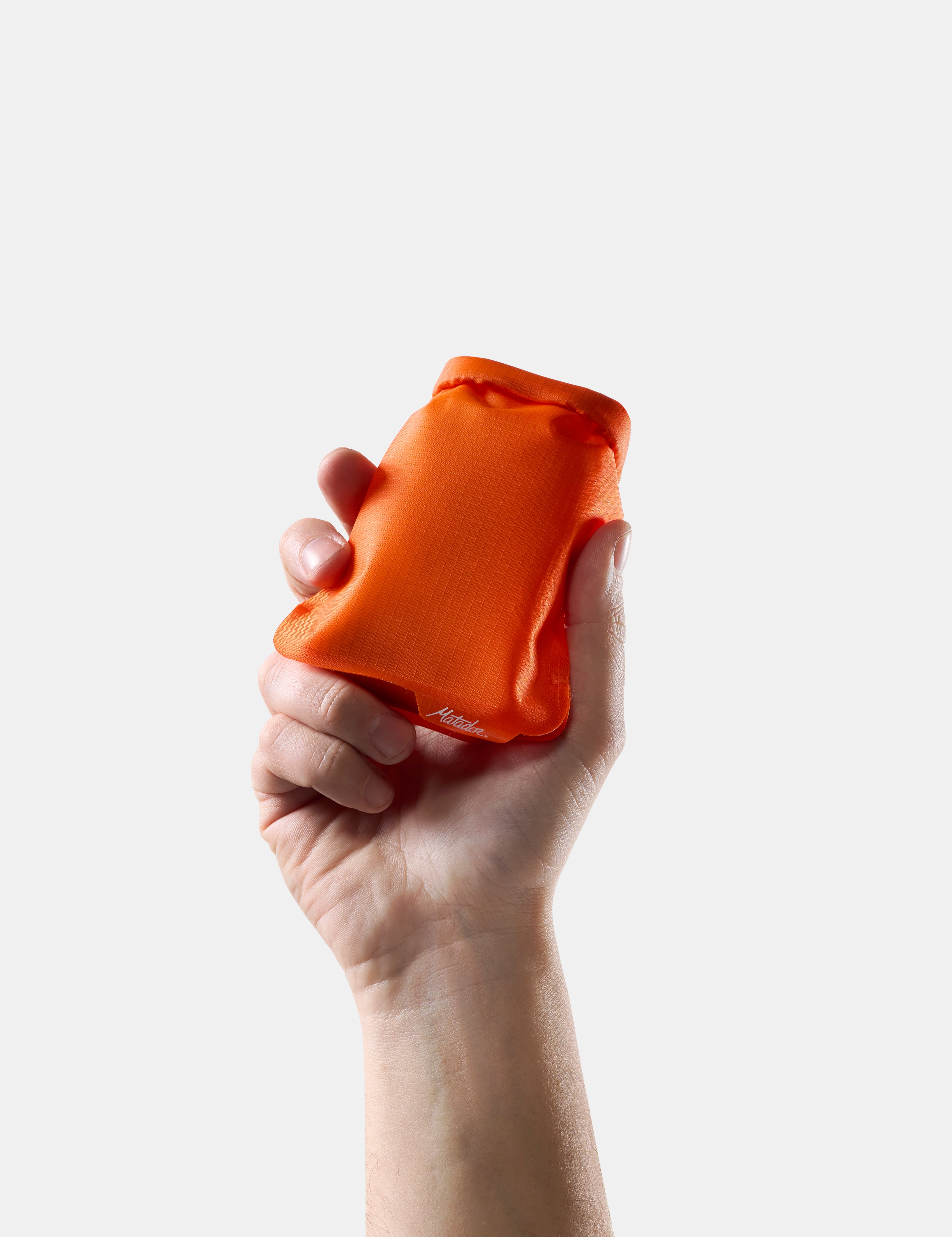 Hand holding an Orange soap bar case against a white background