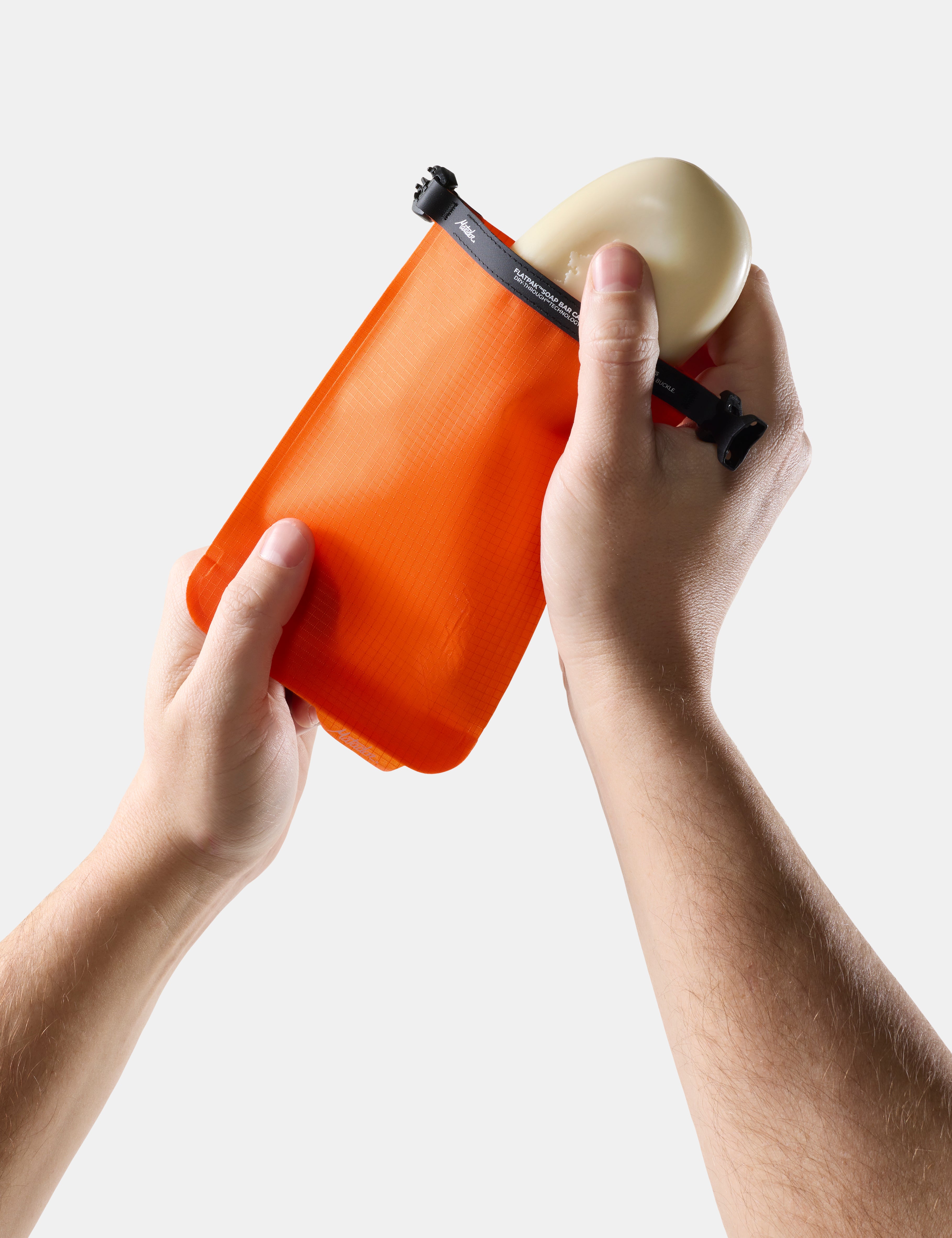 Orange soap bar case with soap on a light gray background