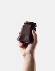 Hand holding Garnet soap bar case against a white background