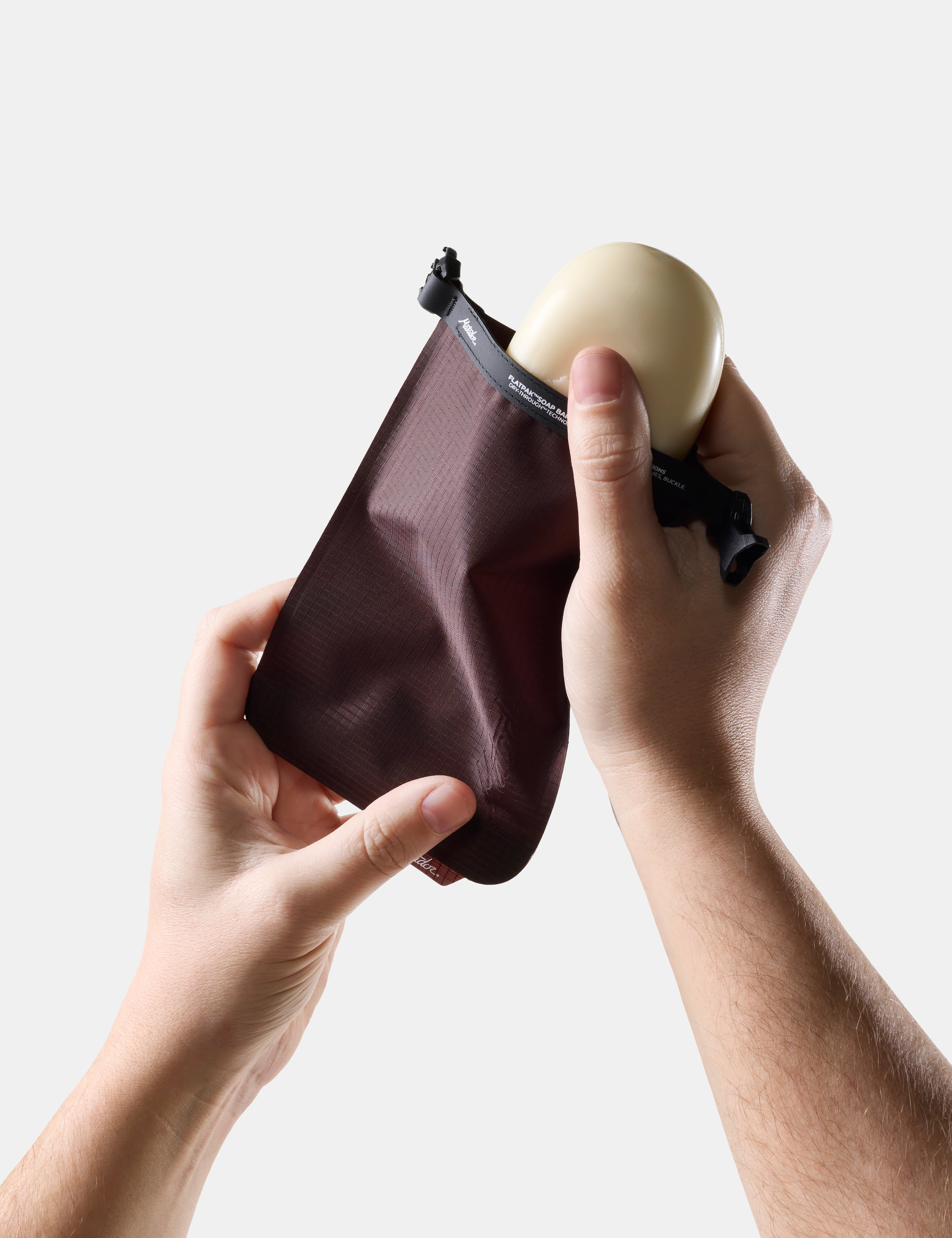 Person holding Garnet soap bar case with soap inside against a light background