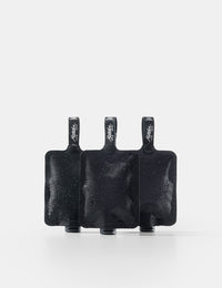 Three black toiletry bottle  on a white background