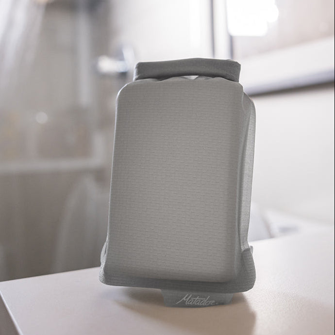 what soap bar case sitting on bathroom counter with shower running in the background