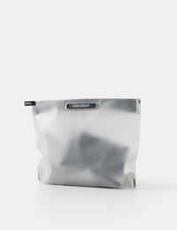 white toiletry case with a black zipper on a white background