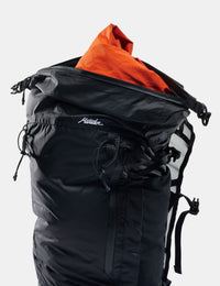 Black backpack with orange interior clothing on a white background