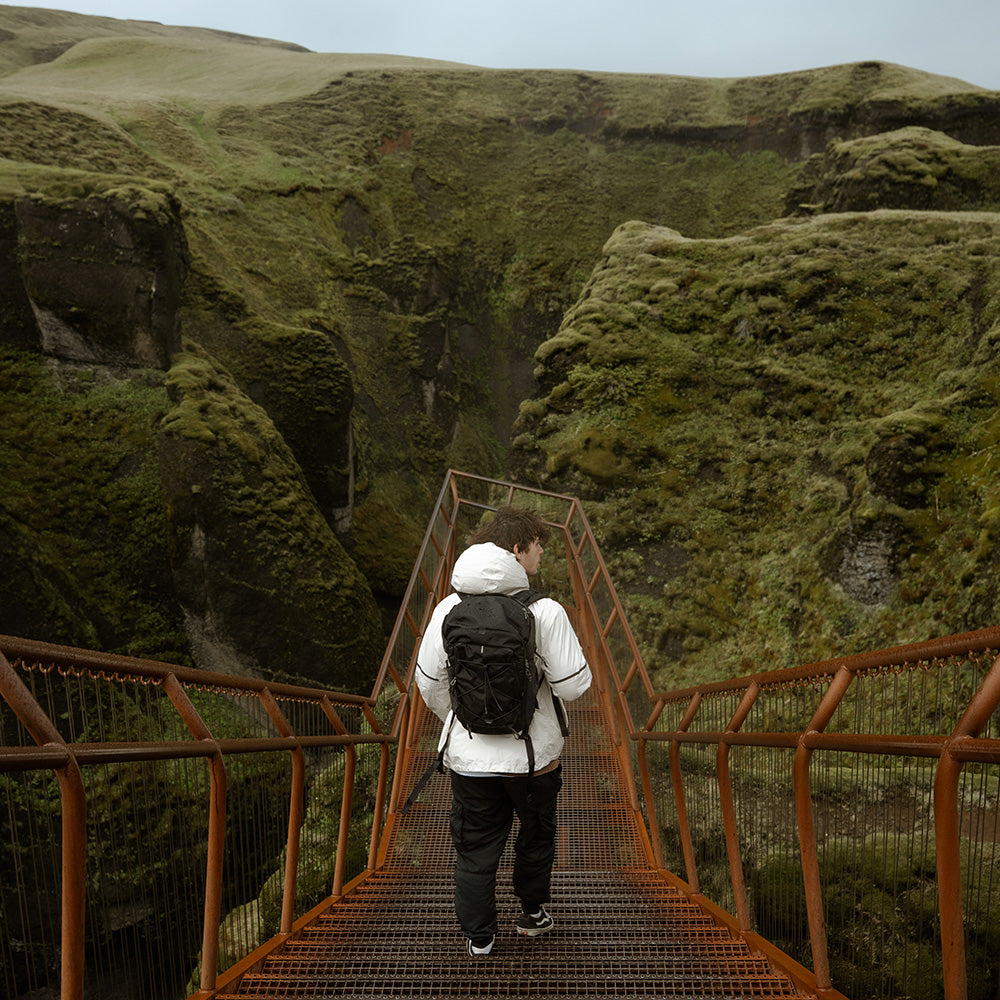 person in Icelandic landscape wearing black backpack
