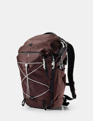 garnet  backpack with white accents on a light gray background