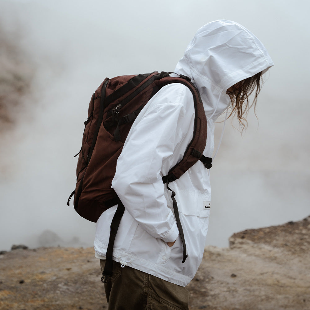 person in foggy conditions wearing garnet backpack
