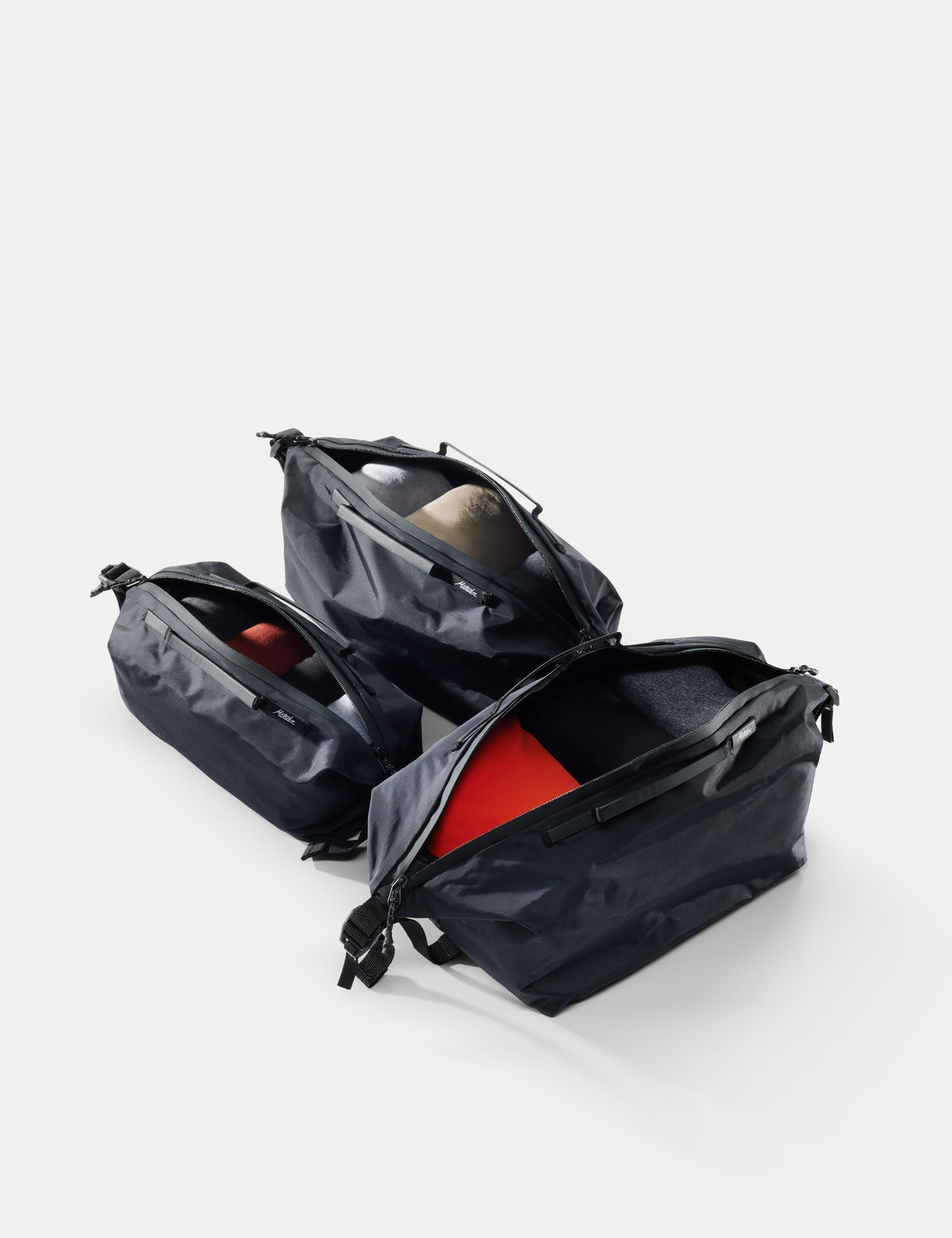 Black travel bag with red interior on a white background