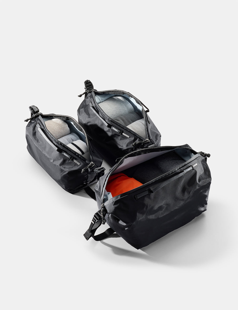 black gear cubes with open compartments on a light gray background