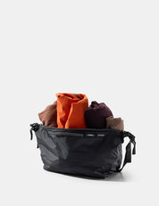 Black gear cube with colorful clothing items on a white background