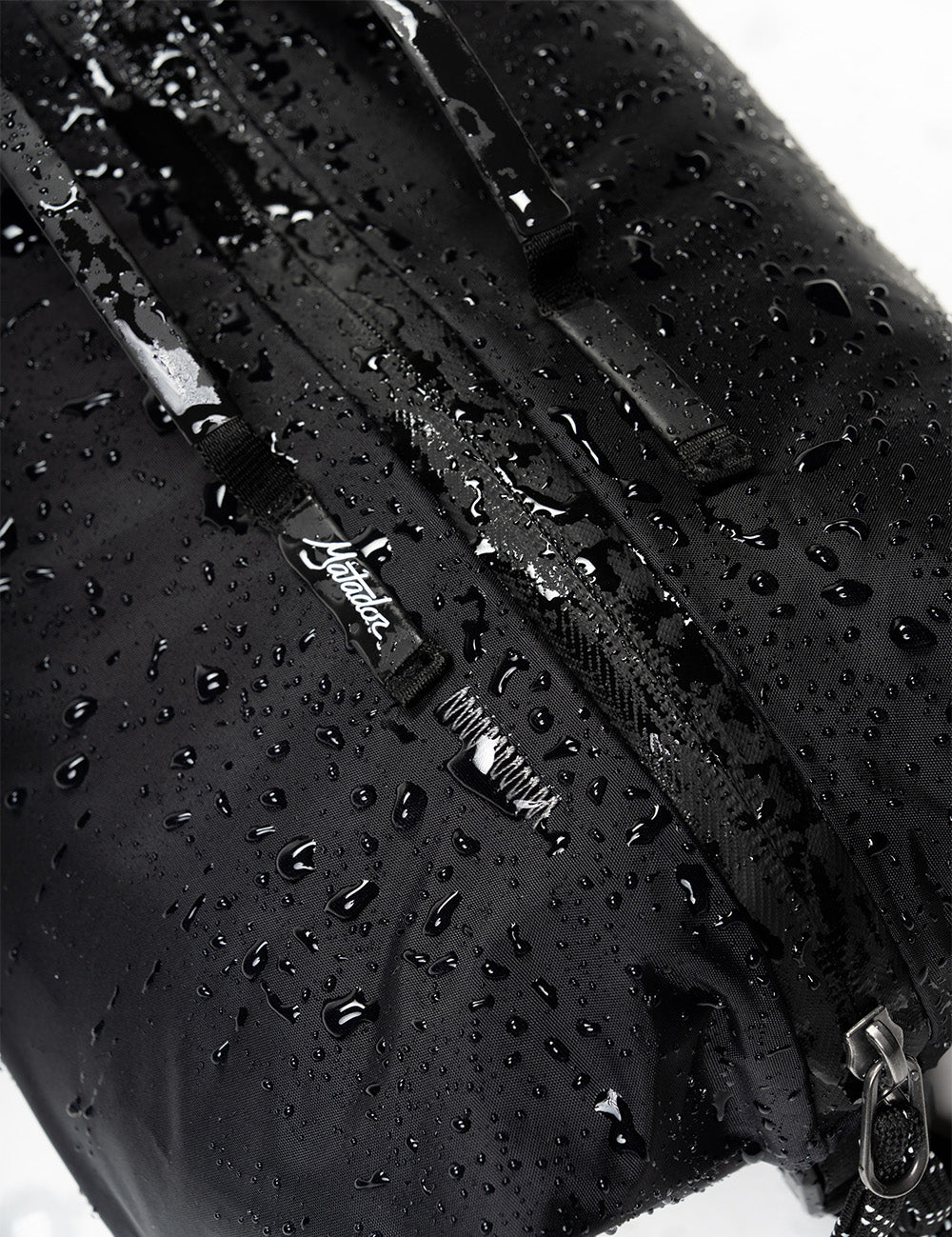 water droplets beading on black fabric