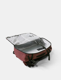 Red backpack with open compartment on a white background