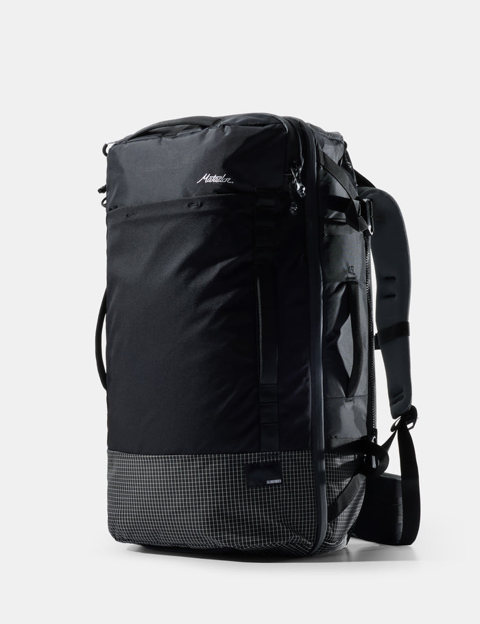 Black travel backpack on a light gray background