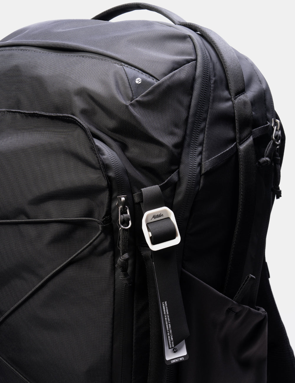 Close-up of a black bag with a strap featuring the Matador logo.